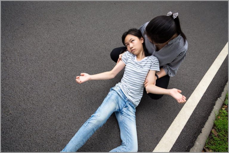 a girl fainting from seizure and another last holding her 