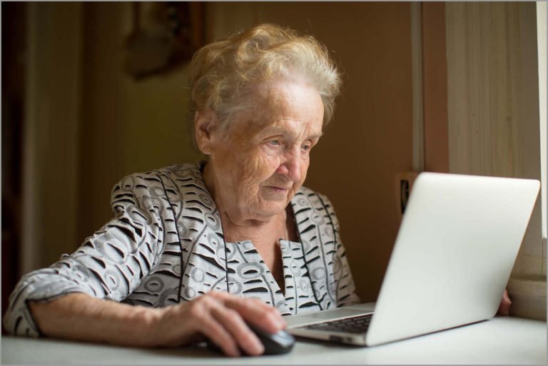 Old lady with vision impairment surfing the web 