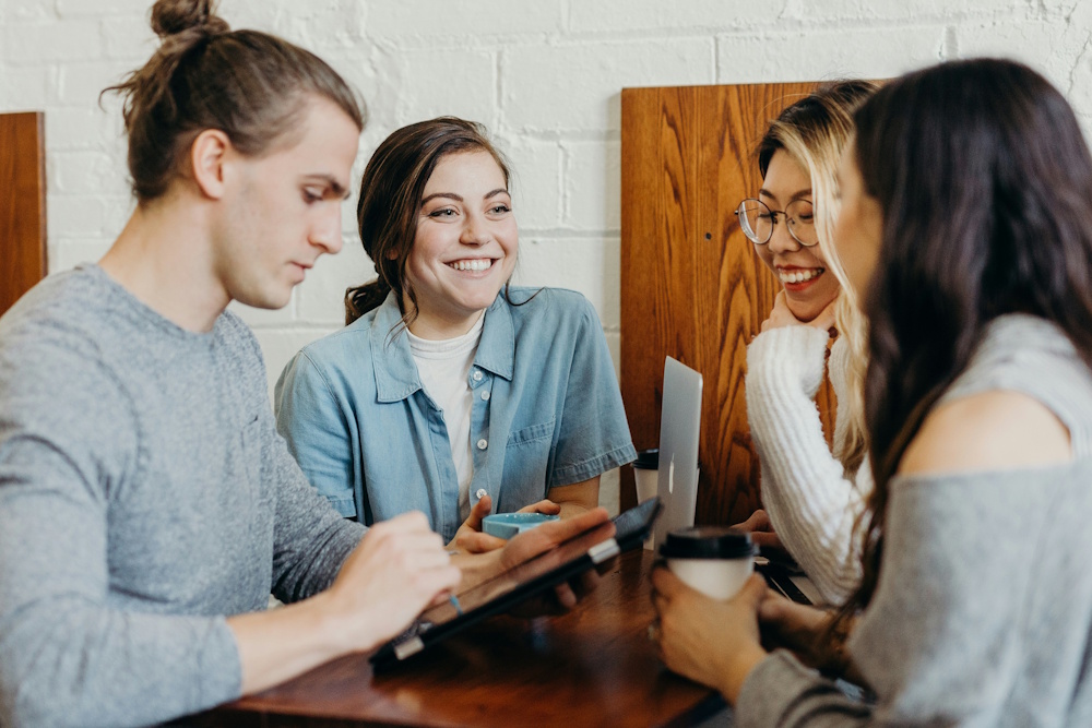 a happy group of customers sitting around a table