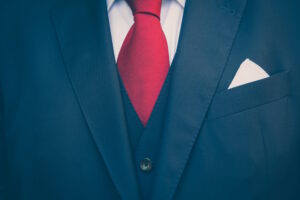 close up of a blue business suit and red tie
