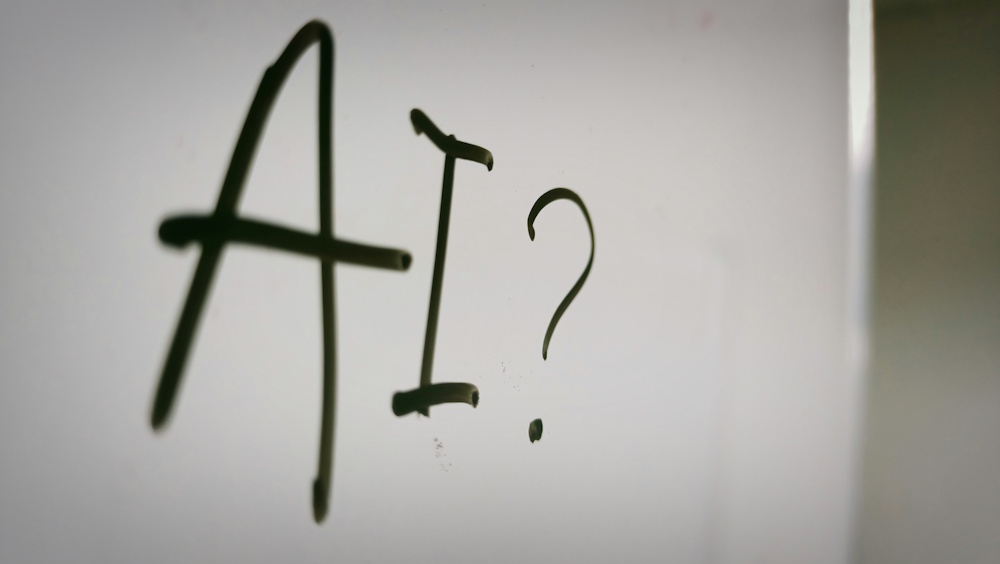 AI text on a white board with a question mark