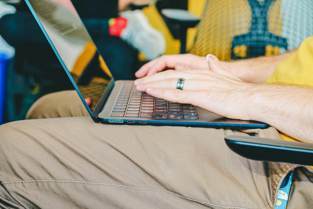 man in a wheelchair typing on a laptop