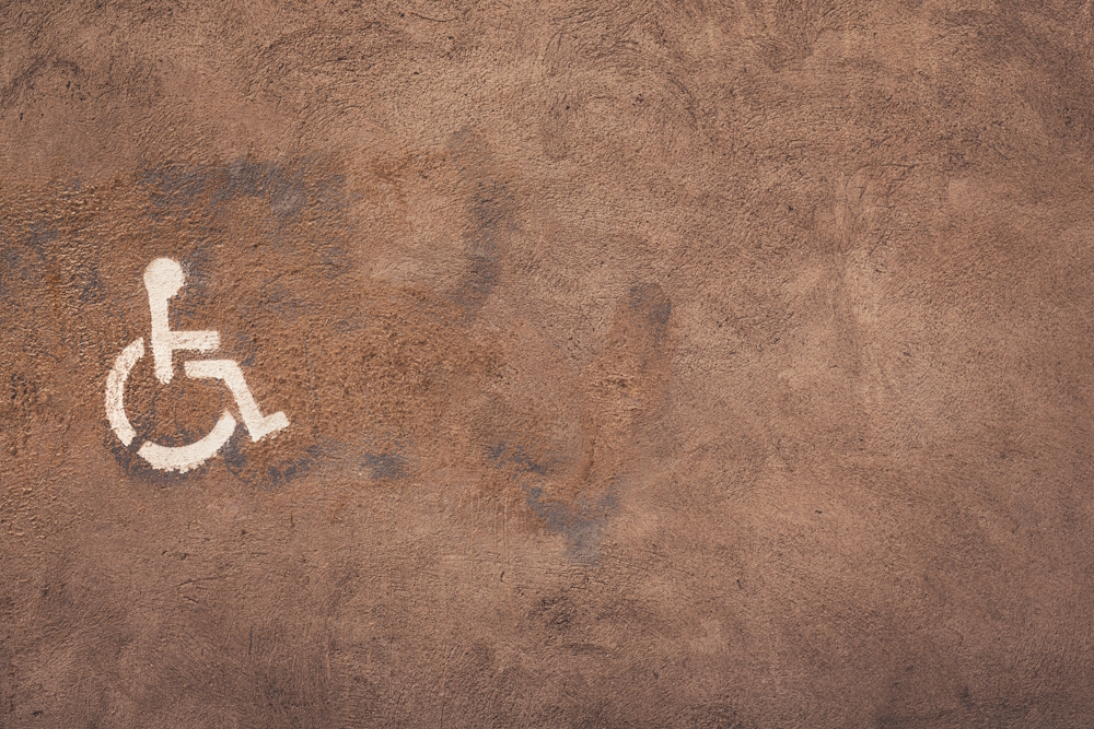 wheelchair symbol painted on concrete