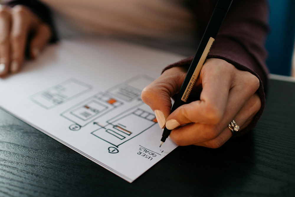 woman mapping out a UX design for a website